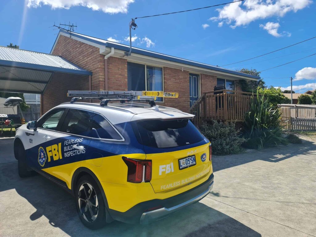 Fearless building Inspections car parked in front of a house for building inspection