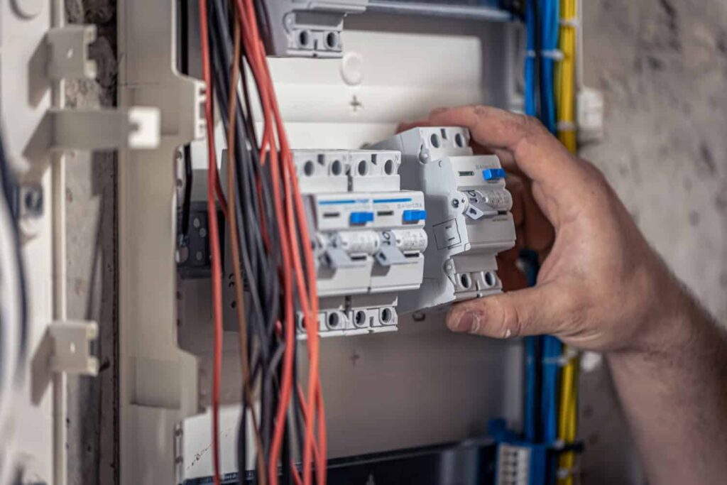 man working on an electrical switchboard