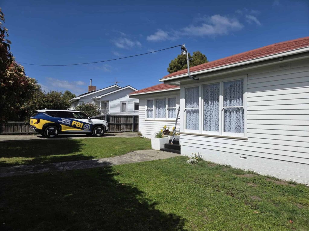 a white house in Hobart with the Fearless Building Inspections car parked at the front